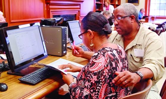 Couple does research at computer in a library